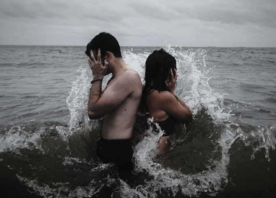 A photo of a couple in the middle of the sea.